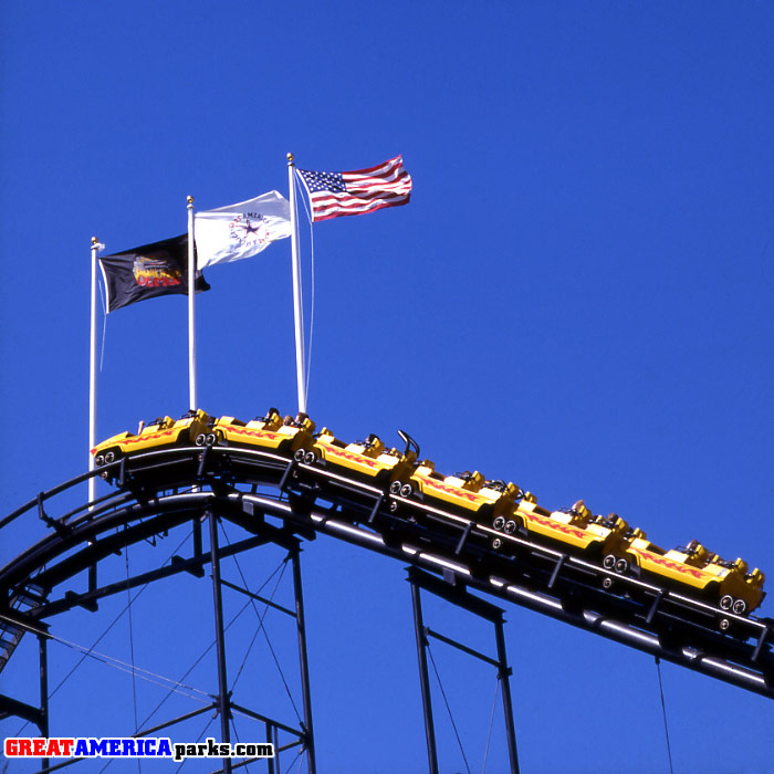 [i]Demon[/i] lift and flags
Santa Clara, CA
Three flagpoles were added to the top of the lift hill when [i]Turn of the Century[/i] was converted into the [i]Demon[/i]. Do not ask me why there is a restraint open in the third car in this photo.
