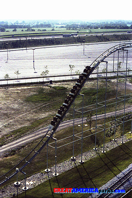 above the [i]Turn of the Century[/i]
Gurnee, IL -- 1977
This look at a train going down the first drop is from the Southern Cross skyride. The Tri-State Tollway is in the background.
Keywords: Gurnee