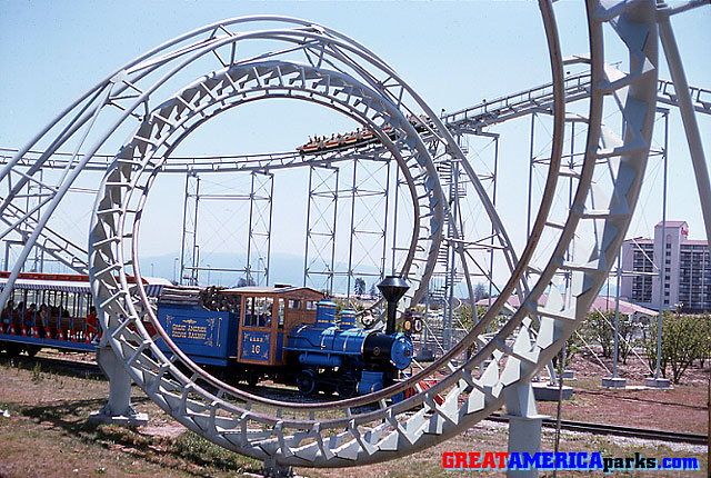 choo-choo and corkscrew
Santa Clara, CA
The GREAT AMERICA Scenic Railway train chugs below the corkscrew element of the [i]Turn of the Century[/i] roller coaster as a coaster train makes its approach. In the background on the right is the Santa Clara Marriott hotel.
