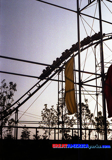 first drop as the sun goes down
Gurnee, IL -- 1977
In silhouette, a train descends the first drop of the [i]Turn of the Century[/i] roller coaster.
Keywords: Gurnee