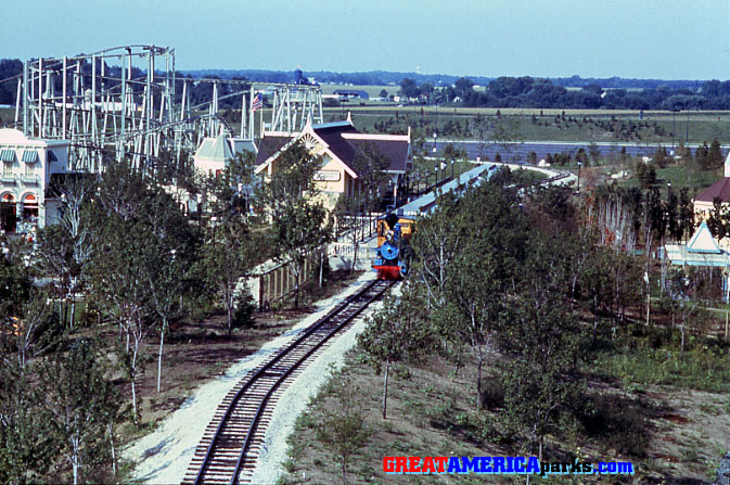 Gurnee
Gurnee, IL
The blue train is seen at the Hometown Square station in Gurnee. The [i]Willard's Whizzer[/i] roller coaster is seen in the background on the left.
Keywords: Gurnee